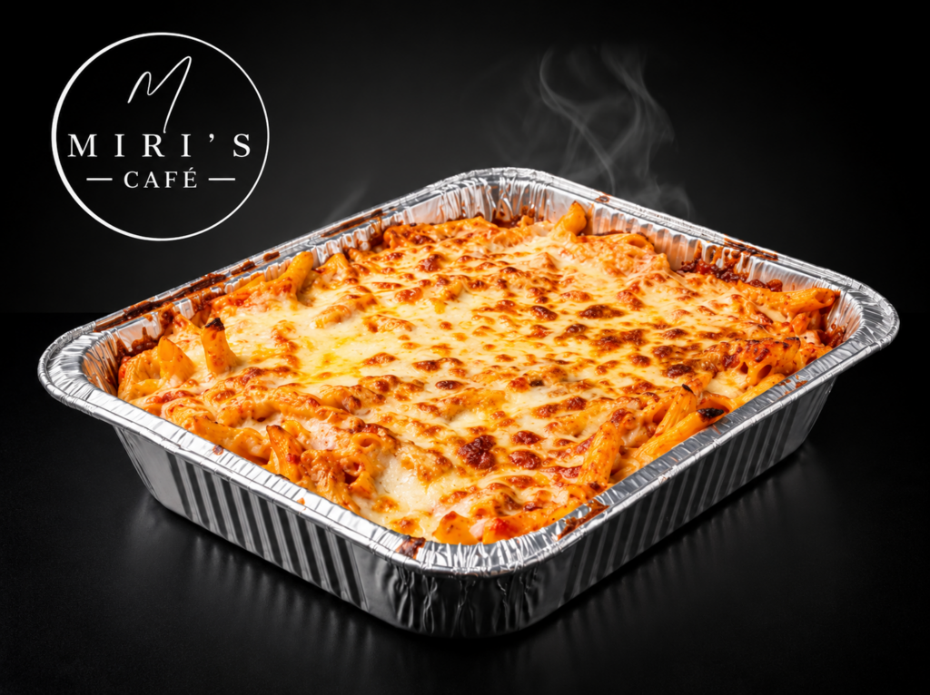 Kosher baked ziti served in a 9x13 catering pan with tomato sauce and melted cheese at Miri's Cafe in Miami Beach